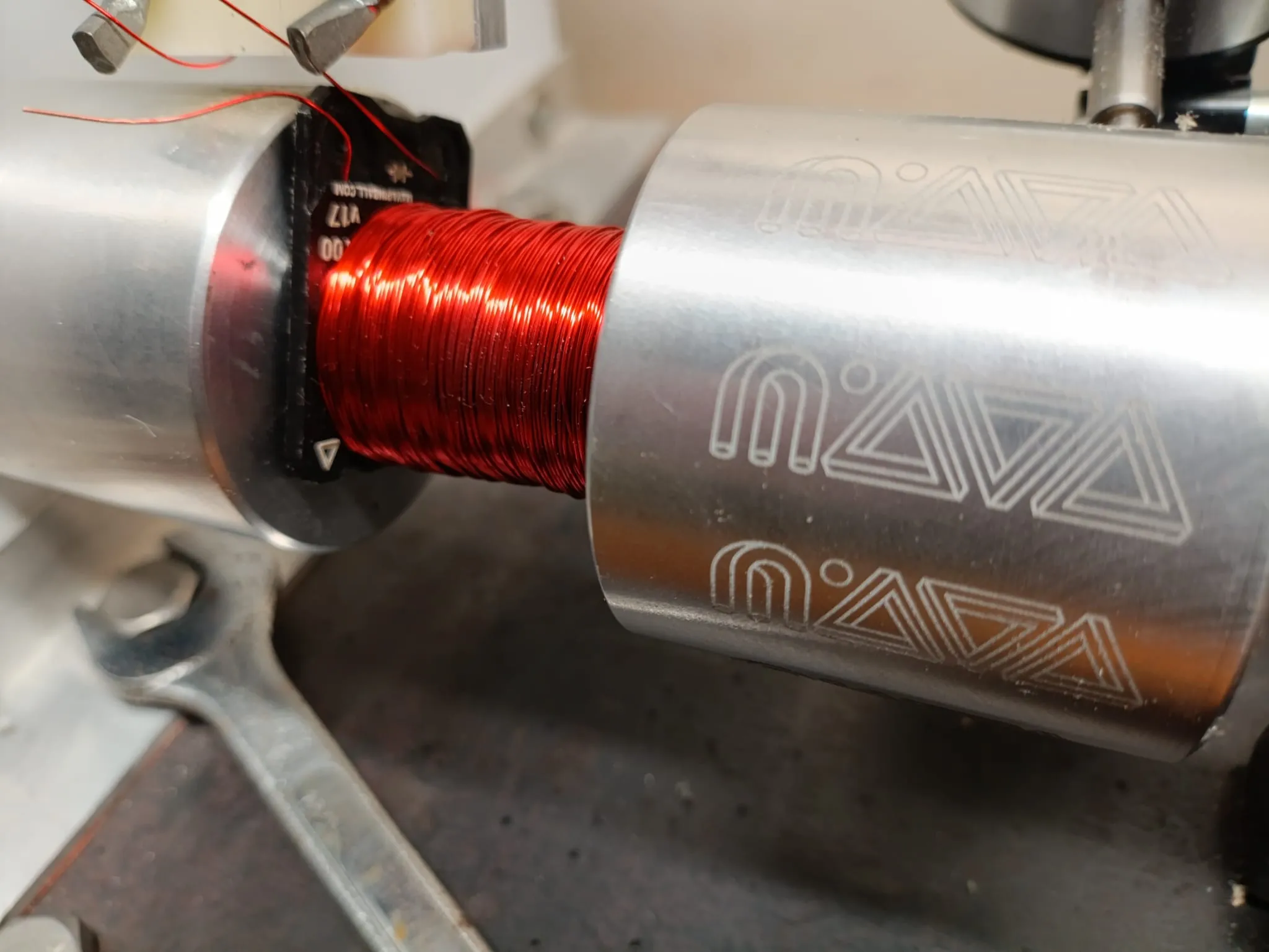 Pinball solenoid coil mounted on industrial coil winding machinery