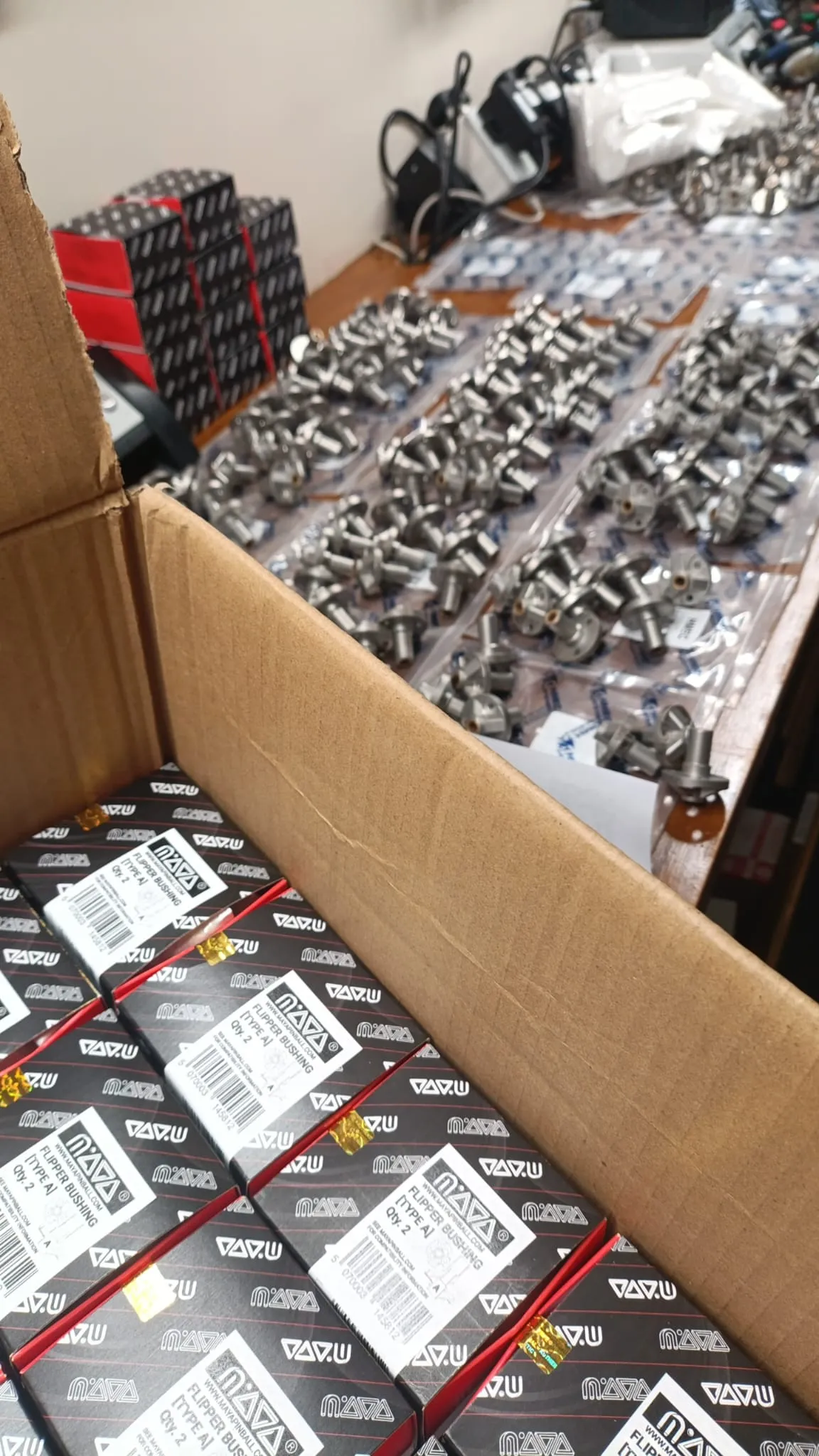 Pinball flipper bushings being sorted and packed